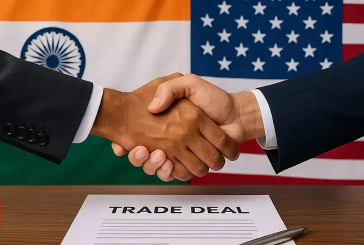 Handshake in front of Indian and U.S. flags
